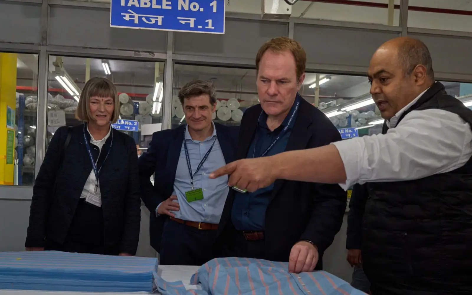 Stadtkämmerin Dorothee Schneider, Wirtschaftsdezernent Christian Zaum und Oberbürgermeister Dr. Stephan Keller (von links) lassen sich von Ravindra Rai die Fertigung eines Oberhemdes zeigen. Foto: Landeshauptstadt Düsseldorf